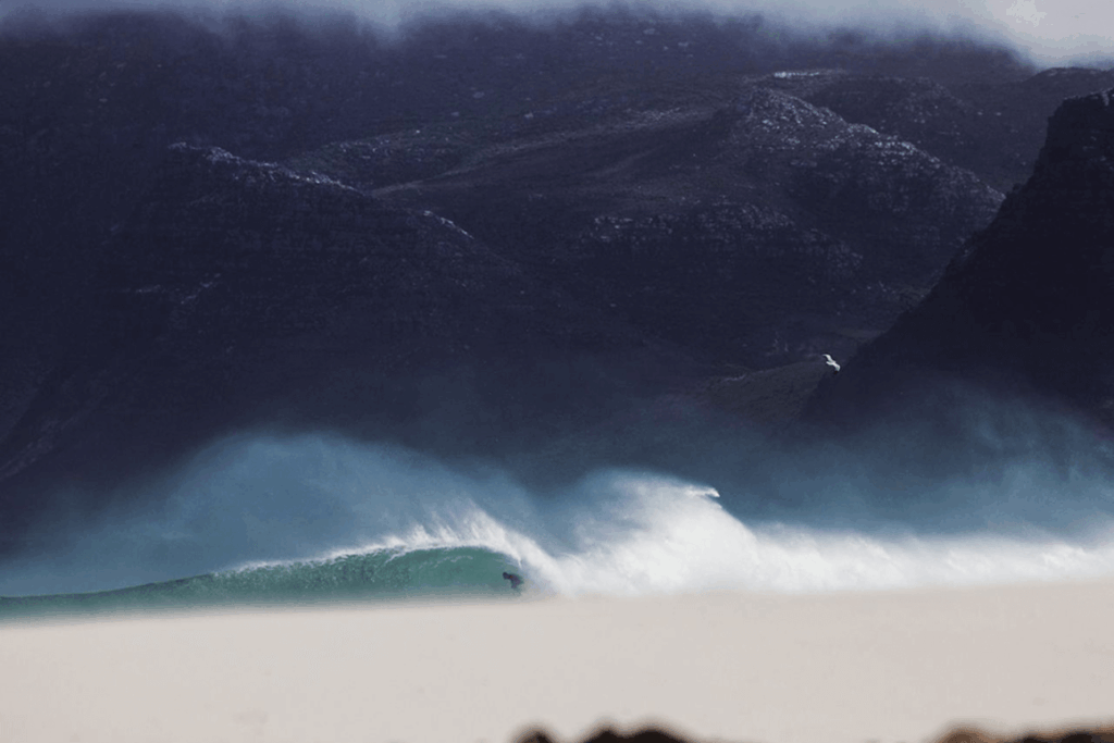 Image of a surfer amid sea tides.