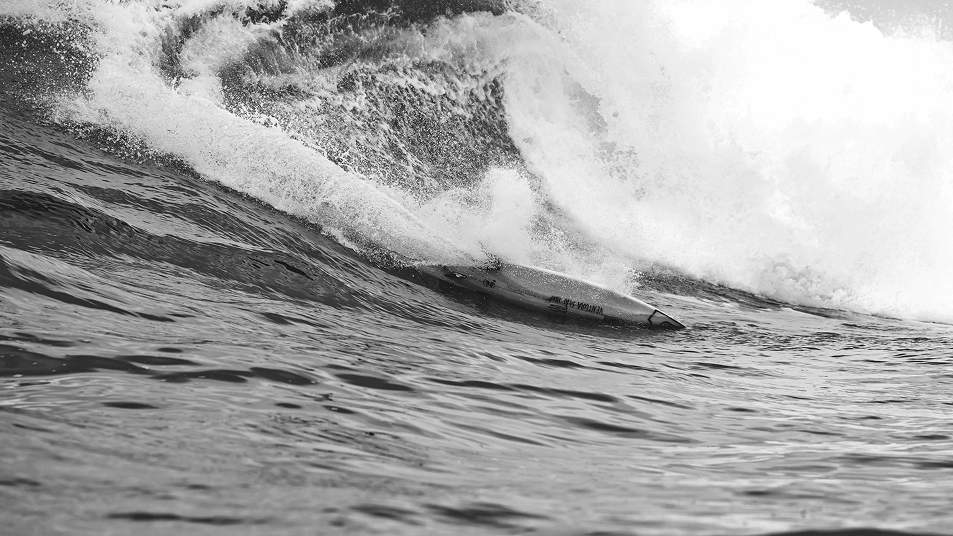 A surfboard on a sea tide.
