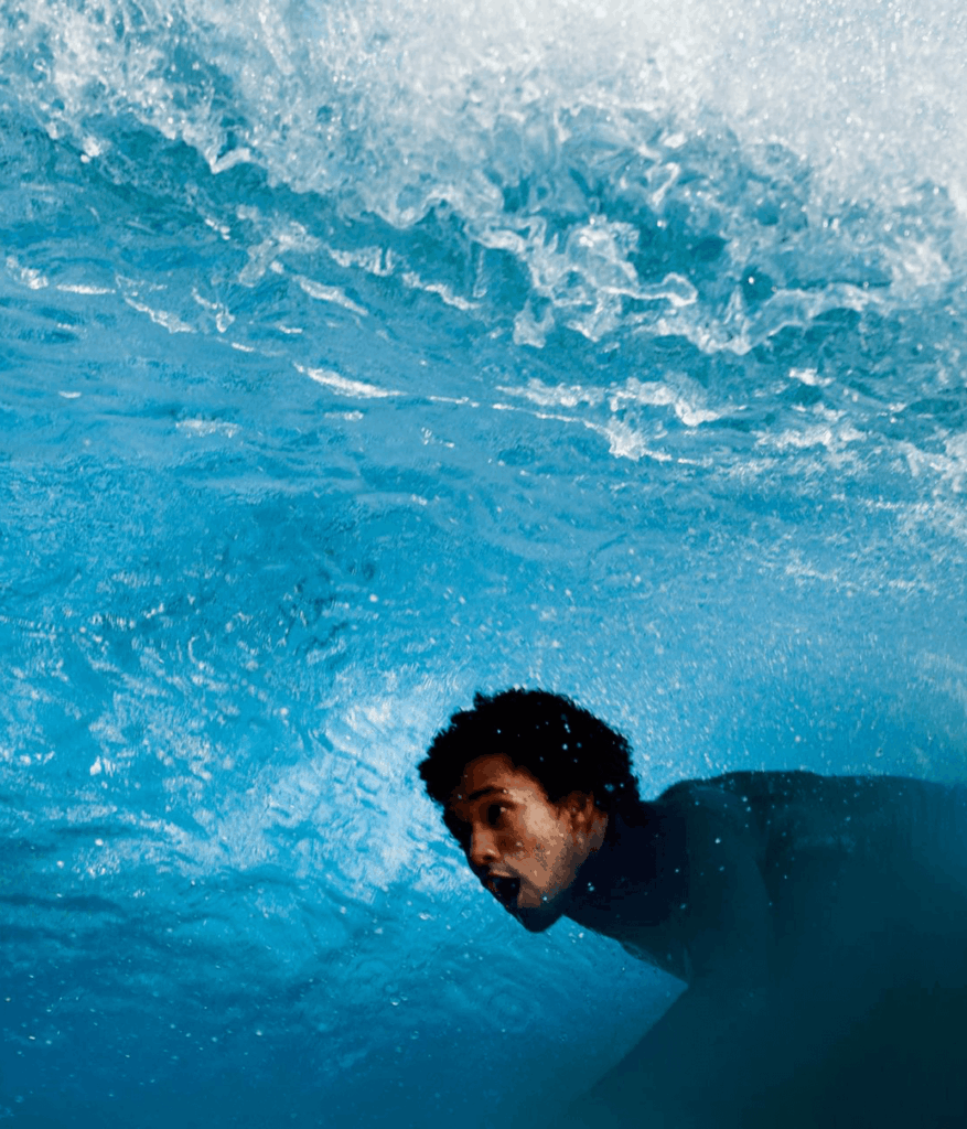 Person swimming, in the sea.